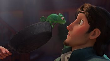 Movie still from “Tangled” (2010), directed by Byron Howard – A person's face and a chameleon; Close Up shot, Over the shoulder angle