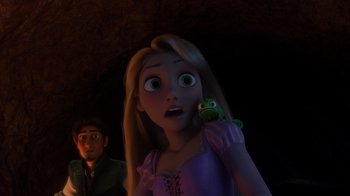 Movie still from “Tangled” (2010), directed by Byron Howard – A young girl holding a frog in front of a young man; Close Up shot, Over the shoulder angle