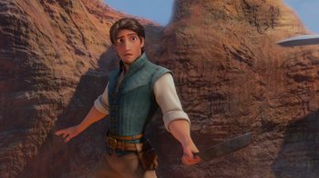 Movie still from “Tangled” (2010), directed by Byron Howard – A man holding a sword in front of a cliff; Medium shot, Over the shoulder angle