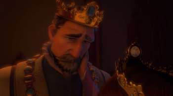 Movie still from “Tangled” (2010), directed by Byron Howard – A man with a beard and a crown is looking down; Close Up shot, Over the shoulder angle