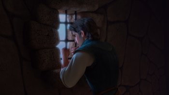 Movie still from “Tangled” (2010), directed by Byron Howard – A man is looking out of a window at a castle; Medium shot, Low angle