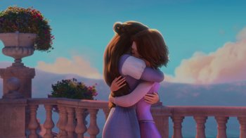 Movie still from “Tangled” (2010), directed by Byron Howard – Two women hugging each other in front of a balcony; Medium shot, Low angle