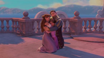 Movie still from “Tangled” (2010), directed by Byron Howard – A man and a woman hugging in front of a rapunzel statue; Wide shot, High angle