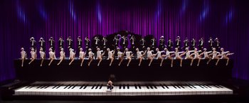 Movie still from “Ted 2” (2015), directed by Seth MacFarlane – A group of men in white shirts and black hats sitting on top of a piano; Extreme Wide shot, Overhead angle