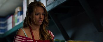 Movie still from “Ted 2” (2015), directed by Seth MacFarlane – A woman with long blonde hair wearing a red and white striped shirt; Close Up shot, Over the shoulder angle