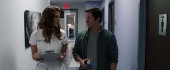 Movie still from “Ted 2” (2015), directed by Seth MacFarlane – A man and a woman talking in a hospital hallway; Medium shot, Over the shoulder angle