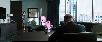 Movie still from “Ted 2” (2015), directed by Seth MacFarlane – A man sitting at a table in a hotel room; Wide shot, Over the shoulder angle