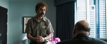 Movie still from “Ted 2” (2015), directed by Seth MacFarlane – A man in a brown shirt talking to another man in a black shirt; Medium shot, Over the shoulder angle