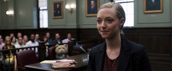 Movie still from “Ted 2” (2015), directed by Seth MacFarlane – A woman in a courtroom with a teddy bear in the background; Close Up shot, Over the shoulder angle