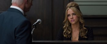 Movie still from “Ted 2” (2015), directed by Seth MacFarlane – A beautiful young woman sitting at a podium; Close Up shot, Over the shoulder angle