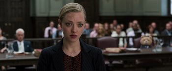 Movie still from “Ted 2” (2015), directed by Seth MacFarlane – Amanda seyfried in front of a group of people in a court room; Close Up shot, Over the shoulder angle