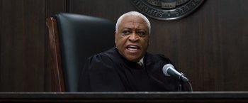Movie still from “Ted 2” (2015), directed by Seth MacFarlane – An older man wearing a black robe in a court room; Close Up shot, Low angle
