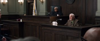 Movie still from “Ted 2” (2015), directed by Seth MacFarlane – Two men sitting in front of a judge in a courtroom; Wide shot, Over the shoulder angle