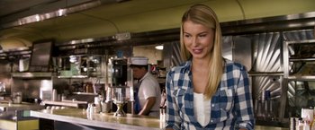 Movie still from “Ted 2” (2015), directed by Seth MacFarlane – A woman standing in front of a counter in a kitchen; Medium shot, Over the shoulder angle