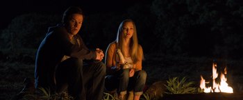 Movie still from “Ted 2” (2015), directed by Seth MacFarlane – Two people sitting on the ground in the dark; Medium shot, High angle