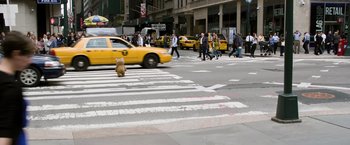 Movie still from “Ted 2” (2015), directed by Seth MacFarlane – A yellow taxi cab driving down a busy city street; Wide shot, Low angle