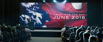 Movie still from “Ted 2” (2015), directed by Seth MacFarlane – A woman is giving a speech in front of an audience; Extreme Wide shot, Over the shoulder angle
