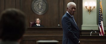 Movie still from “Ted 2” (2015), directed by Seth MacFarlane – An older man in a suit stands in front of a judge in a courtroom; Medium shot, Low angle