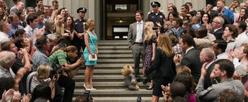 Movie still from “Ted 2” (2015), directed by Seth MacFarlane – A group of people standing around a teddy bear on the steps; Wide shot, Low angle