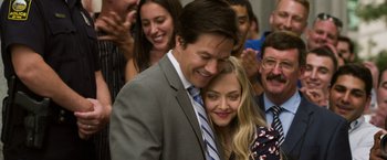 Movie still from “Ted 2” (2015), directed by Seth MacFarlane – A man and a woman hugging in front of a group of people; Close Up shot, Over the shoulder angle