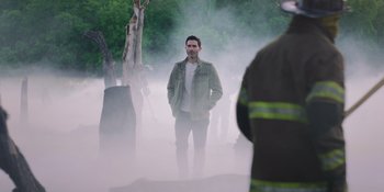 Movie still from “Teen Wolf: The Movie” (2023), directed by Russell Mulcahy – A man standing in the middle of a foggy forest; Medium shot, Over the shoulder angle