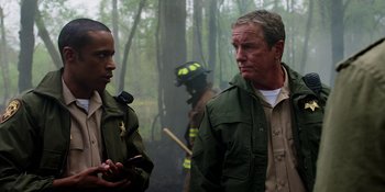 Movie still from “Teen Wolf: The Movie” (2023), directed by Russell Mulcahy – Two men in the woods talking to each other; Medium shot, Over the shoulder angle