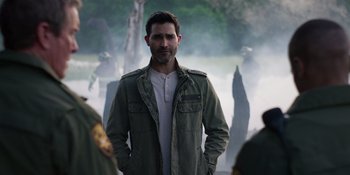 Movie still from “Teen Wolf: The Movie” (2023), directed by Russell Mulcahy – A man standing in front of a group of people; Medium shot, Over the shoulder angle