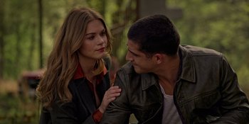 Movie still from “Teen Wolf: The Movie” (2023), directed by Russell Mulcahy – A man and a woman sitting next to each other on the ground; Close Up shot, Over the shoulder angle