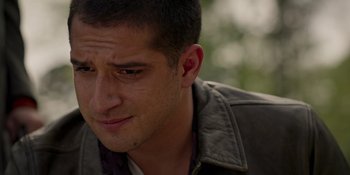 Movie still from “Teen Wolf: The Movie” (2023), directed by Russell Mulcahy – A man's face with trees in the background; Close Up shot, Over the shoulder angle