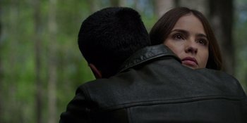 Movie still from “Teen Wolf: The Movie” (2023), directed by Russell Mulcahy – A man and a woman hugging each other in a forest; Close Up shot, Over the shoulder angle