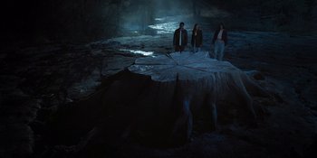 Movie still from “Teen Wolf: The Movie” (2023), directed by Russell Mulcahy – A group of people standing next to each other in the dark; Wide shot, Overhead angle