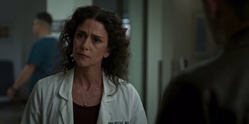 Movie still from “Teen Wolf: The Movie” (2023), directed by Russell Mulcahy – A woman wearing a white lab coat looking at the camera; Close Up shot, Over the shoulder angle