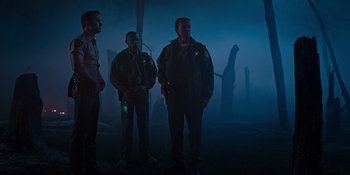 Movie still from “Teen Wolf: The Movie” (2023), directed by Russell Mulcahy – A group of men standing next to each other in the dark; Wide shot, Low angle