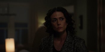 Movie still from “Teen Wolf: The Movie” (2023), directed by Russell Mulcahy – A woman with curly hair is looking at the camera; Close Up shot, Over the shoulder angle