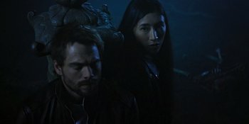 Movie still from “Teen Wolf: The Movie” (2023), directed by Russell Mulcahy – A man and a woman standing next to each other in the dark; Close Up shot, Low angle