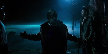 Movie still from “Teen Wolf: The Movie” (2023), directed by Russell Mulcahy – A man in a leather jacket and a mask; Medium shot, Low angle