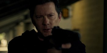 Movie still from “Teen Wolf: The Movie” (2023), directed by Russell Mulcahy – A person holding a gun; Close Up shot, Over the shoulder angle