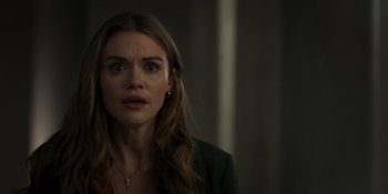 Movie still from “Teen Wolf: The Movie” (2023), directed by Russell Mulcahy – A woman with long brown hair stares into the camera; Close Up shot, Over the shoulder angle