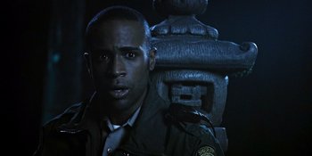 Movie still from “Teen Wolf: The Movie” (2023), directed by Russell Mulcahy – A person wearing a uniform near a fire hydrant; Close Up shot, Over the shoulder angle