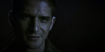 Movie still from “Teen Wolf: The Movie” (2023), directed by Russell Mulcahy – A person's face in the dark; Close Up shot, Over the shoulder angle