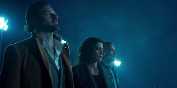 Movie still from “Teen Wolf: The Movie” (2023), directed by Russell Mulcahy – A group of people standing next to each other in the dark; Medium shot, Low angle