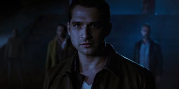 Movie still from “Teen Wolf: The Movie” (2023), directed by Russell Mulcahy – A person wearing a brown jacket; Close Up shot, Over the shoulder angle