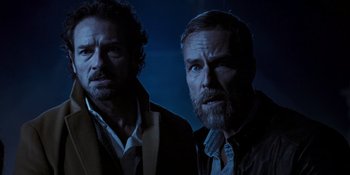 Movie still from “Teen Wolf: The Movie” (2023), directed by Russell Mulcahy – A couple of men standing next to each other; Close Up shot, Low angle