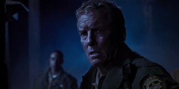 Movie still from “Teen Wolf: The Movie” (2023), directed by Russell Mulcahy – A person in a military uniform; Close Up shot, Over the shoulder angle
