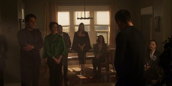 Movie still from “Teen Wolf: The Movie” (2023), directed by Russell Mulcahy – A group of people standing in a living room; Wide shot, Low angle