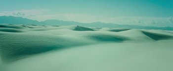 Movie still from “Teenage Mutant Ninja Turtles” (2014), directed by Jonathan Liebesman – A view of a desert with a person standing on top of it; Extreme Wide shot, High angle
