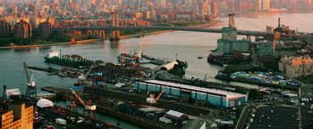 Movie still from “Teenage Mutant Ninja Turtles” (2014), directed by Jonathan Liebesman – An aerial view of a harbor with a city in the background; Extreme Wide shot, High angle