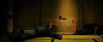 Movie still from “Teenage Mutant Ninja Turtles” (2014), directed by Jonathan Liebesman – A man laying on the ground in a room; Medium shot, Overhead angle