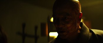 Movie still from “Teenage Mutant Ninja Turtles” (2014), directed by Jonathan Liebesman – A man with a shaved bald head is looking at the camera; Close Up shot, Low angle