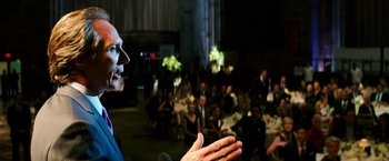 Movie still from “Teenage Mutant Ninja Turtles” (2014), directed by Jonathan Liebesman – A crowd of people sitting in a room; Close Up shot, Over the shoulder angle